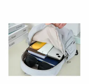Internal view of spacious light gray nylon backpack with organized storage compartments