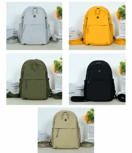 Selection of casual backpacks in five colors: light grey, yellow, green, black, and khaki