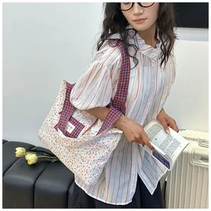 Detailed view of the floral tote bag with blue and orange plaid pockets for daily use