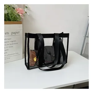 Macro detail of transparent PVC tote bag with black webbing trim and spacious interior
