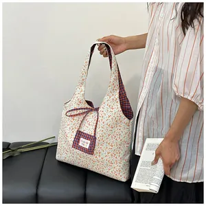 Close-up of floral and plaid pattern stitching on a large capacity tote bag