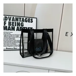 Detail of transparent PVC tote bag set with black canvas straps and inner pouch