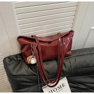 Macro shot of dark red glossy leather tote bag with embossed CLEAROK logo on front