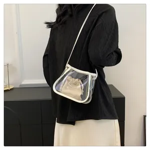 Detailed side view of minimalist clear PVC crossbody bag with beige drawstring inner pouch