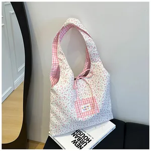 Detail of floral tote bag showing blue-purple patterns and pink plaid drawstring closure