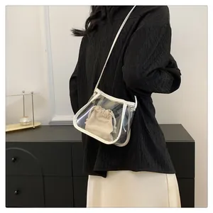 Detail of transparent PVC crossbody bag with white leather trim and drawstring liner