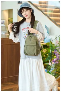 Detail of army green nylon shoulder bag with adjustable strap for outdoor travel