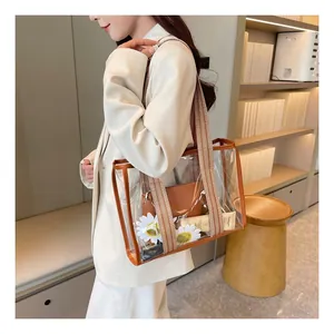 Detail of transparent PVC tote bag with striped wide strap and brown leather pouch