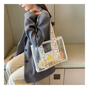 Detail of transparent PVC tote bag with wide geometric letter print shoulder strap