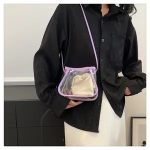 Detail view of transparent PVC crossbody bag with purple trim and interior drawstring pouch