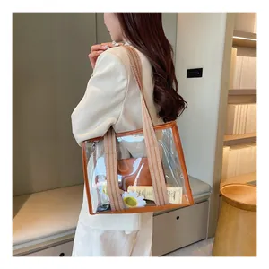 Detailed view of clear PVC tote bag with brown trim showing interior storage and capacity
