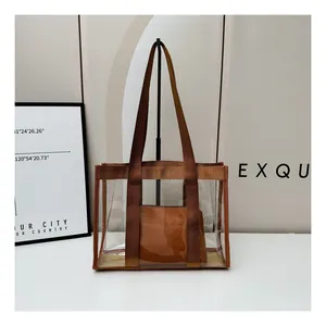 Detail view of transparent PVC tote bag with brown straps and removable inner pouch