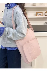 Pink oxford tote bag detail showing large front zipper pocket for daily essentials