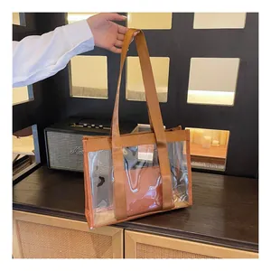 Detailed shot of transparent PVC tote bag with brown straps and inner zipper pouch