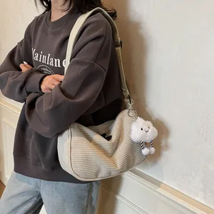 Minimalist beige corduroy crossbody dumpling bag with a cute plush cloud pendant charm