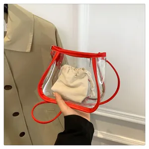 Detail of transparent PVC crossbody bag with red leather trim and cotton drawstring insert