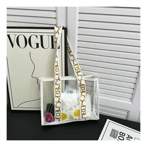 Spacious transparent tote bag with white trim, pattern strap and internal daisy pouch
