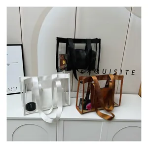 Three transparent PVC tote bags with inner pouches in black, white, and brown on a shelf
