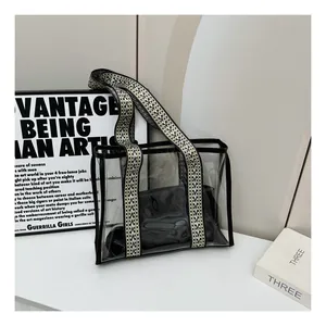 Detail of transparent PVC tote bag with geometric wide strap and black inner pouch