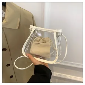 Detailed shot of transparent PVC crossbody bag with white trim and drawstring inner pouch
