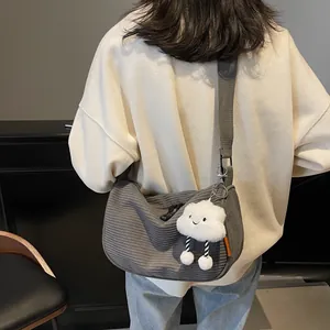 Gray corduroy dumpling crossbody bag with wide strap and cute cloud charm accessory