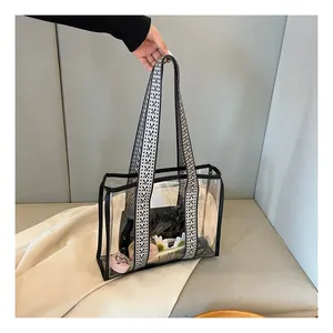 Detail of transparent PVC tote bag with wide geometric woven shoulder strap and large capacity