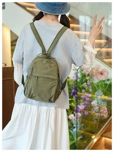Detail view of military green nylon backpack showing adjustable straps and large capacity