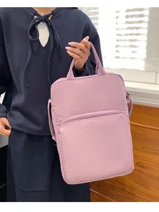 Close-up of lilac Oxford cloth tote showing the front zipper pocket and shoulder strap