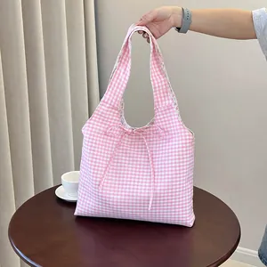 Double-sided pink checkered canvas tote bag with a ribbon bow for casual commuting