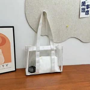 Minimalist transparent PVC tote bag with white nylon handles on a wooden table