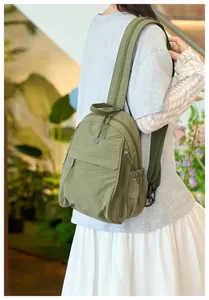 Detailed view of the olive green nylon backpack with waterproof fabric and side pocket