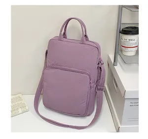 Close-up of purple nylon tote bag featuring durable handles and adjustable shoulder strap