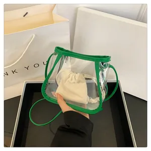 Detail view of transparent green PVC crossbody bag with a cream canvas drawstring inner pouch