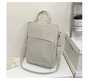 Detail of beige Oxford fabric tote bag with textured surface and adjustable shoulder strap