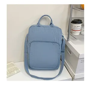 Macro detail of Morandi blue Oxford fabric laptop bag with reinforced handles and zippers