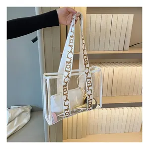Detail of transparent jelly tote bag with wide geometric strap and white inner pouch