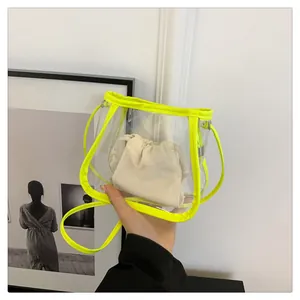Detail of transparent PVC bucket bag with neon yellow trim and canvas inner pouch