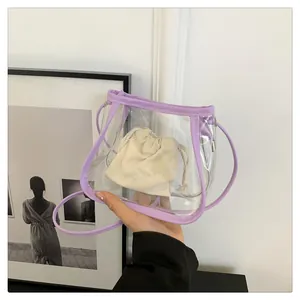 Detailed view of clear PVC tote with lavender trim and ivory drawstring cotton pouch