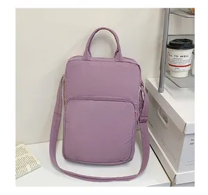 Detail of purple pleated nylon laptop bag with shoulder strap and zippered outer pocket