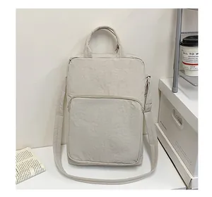 Close-up of the beige oxford fabric shoulder bag featuring a front zipper pocket