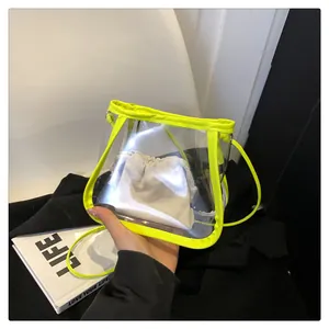 Close-up of transparent PVC bucket bag with neon yellow trim and drawstring inner pouch