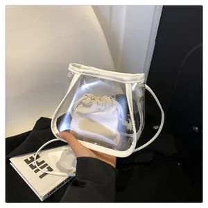 Detail of transparent PVC mini bucket bag with white trim and beige drawstring inner pouch