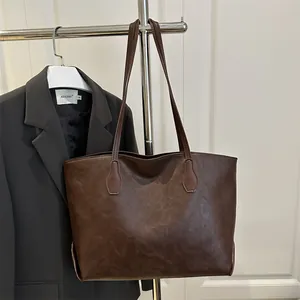 Large dark brown vintage oil leather tote bag for women showing a retro commuter style