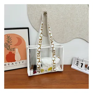 Detail of transparent PVC tote bag with stylish geometric pattern wide strap and white inner pouch