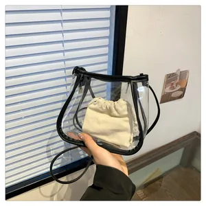 Detail of transparent PVC crossbody bag with black leather trim and canvas drawstring liner