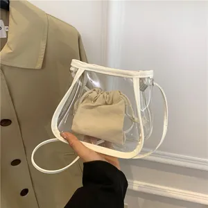 Minimalist transparent PVC bucket bag with cream canvas inner pouch and white leather trim