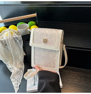 Detail view of New Chinese style phone bag with floral metal clasp and beige piping