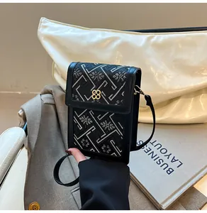 Detail of black New Chinese style crossbody bag with floral jacquard and gold metal buckle