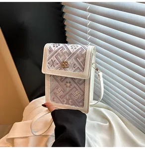Detail of Chinese style embroidery floral pattern on white crossbody mobile phone bag