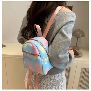 Detail of macaron gradient mini backpack with star patterns and gold flower zippers